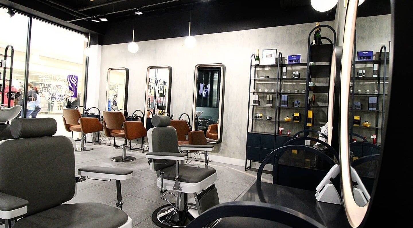 Chic interior of Laird Law For Him & For Her in Ballymena, Northern Ireland, GB with modern salon chairs and mirrors.