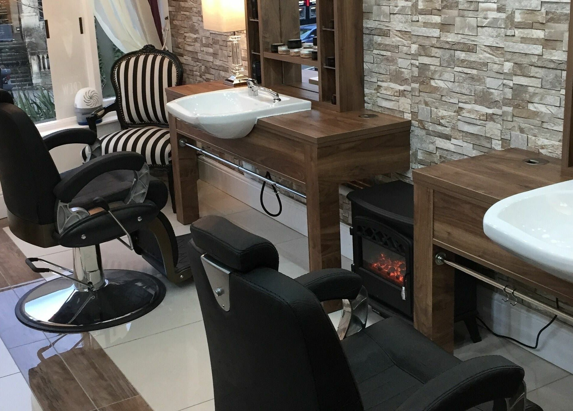 Modern barber chairs and sinks at Berkeley Barbers, Bristol, England, GB showcasing sleek and stylish design.