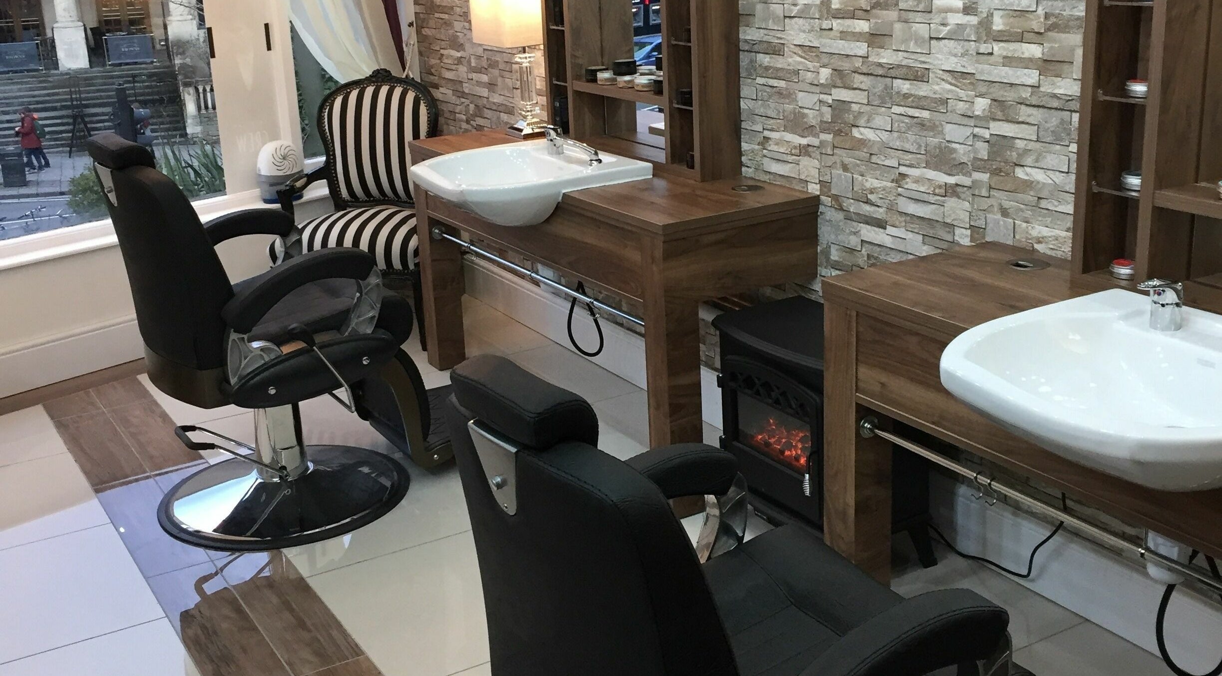 Modern barber chairs and sinks at Berkeley Barbers, Bristol, England, GB showcasing sleek and stylish design.