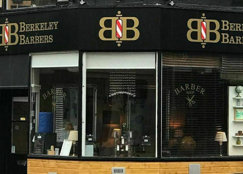 Chic exterior view of Berkeley Barbers at Bristol, England, GB showcasing modern design.