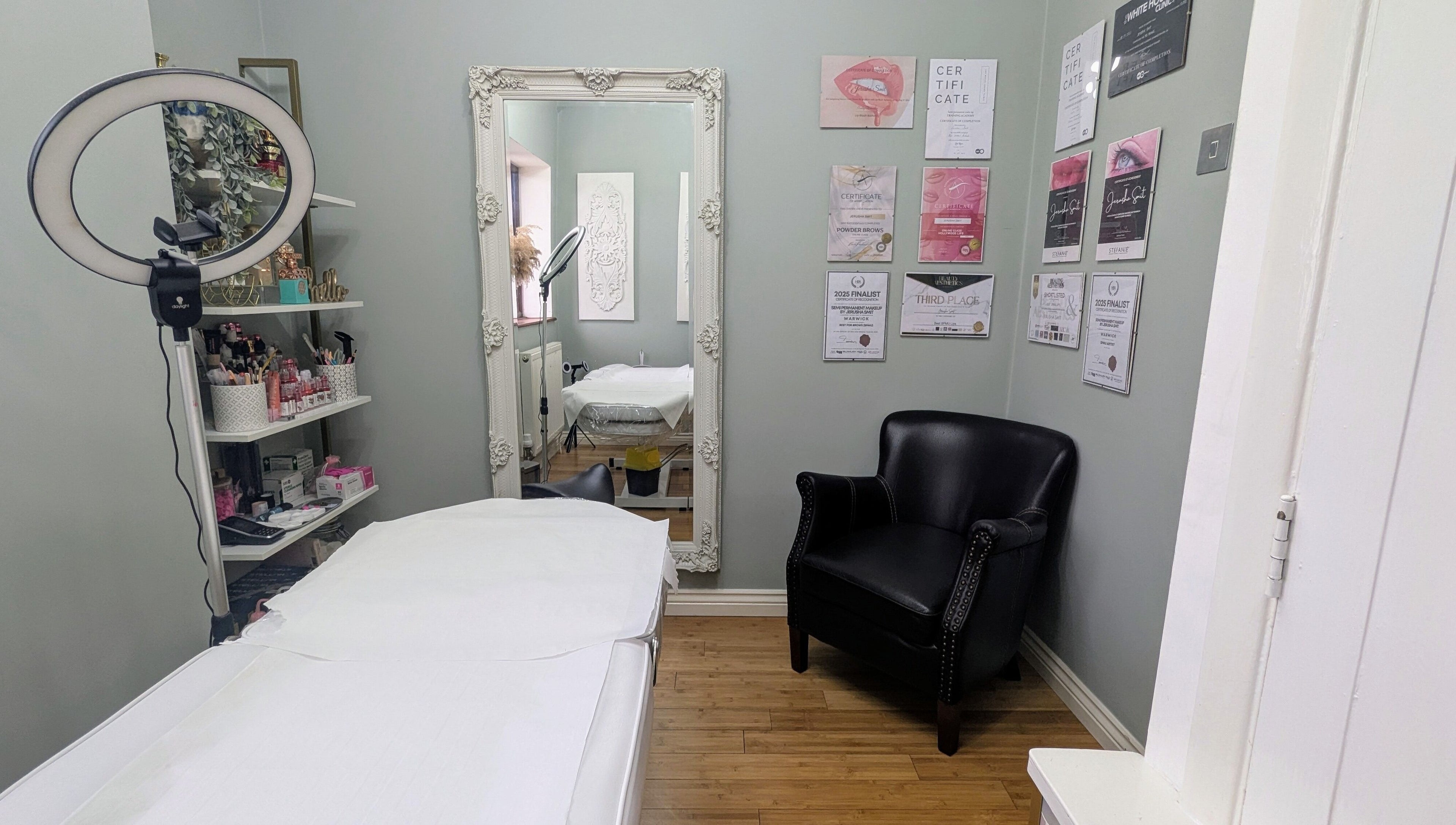 Treatment room at Semi Permanent Makeup by Jerusha Smit, Warwick, England, GB with chair, mirror, and decor.