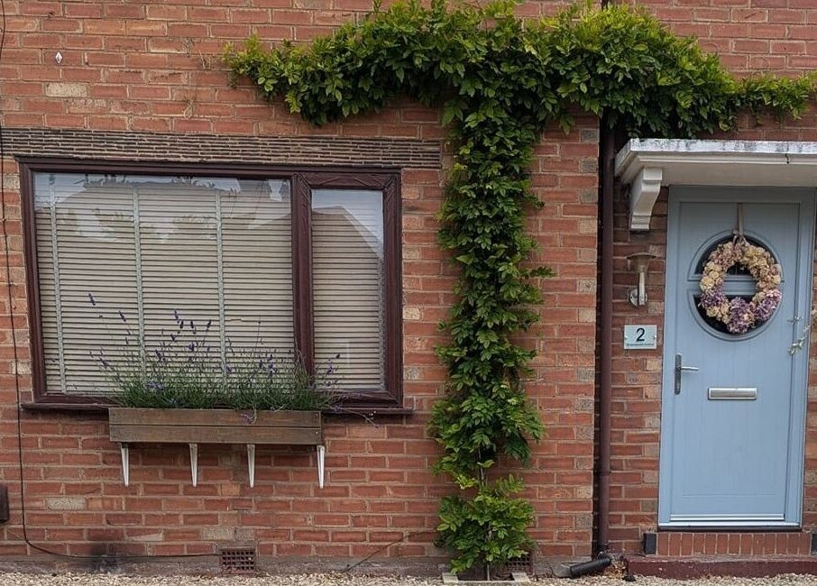 Charming brick facade with blue door at Semi Permanent Makeup by Jerusha Smit, Warwick, England, GB.