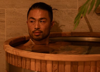 Relaxing soak at Studio Sweat in Auckland, NZ. Enjoy rejuvenation in a serene wooden tub environment.