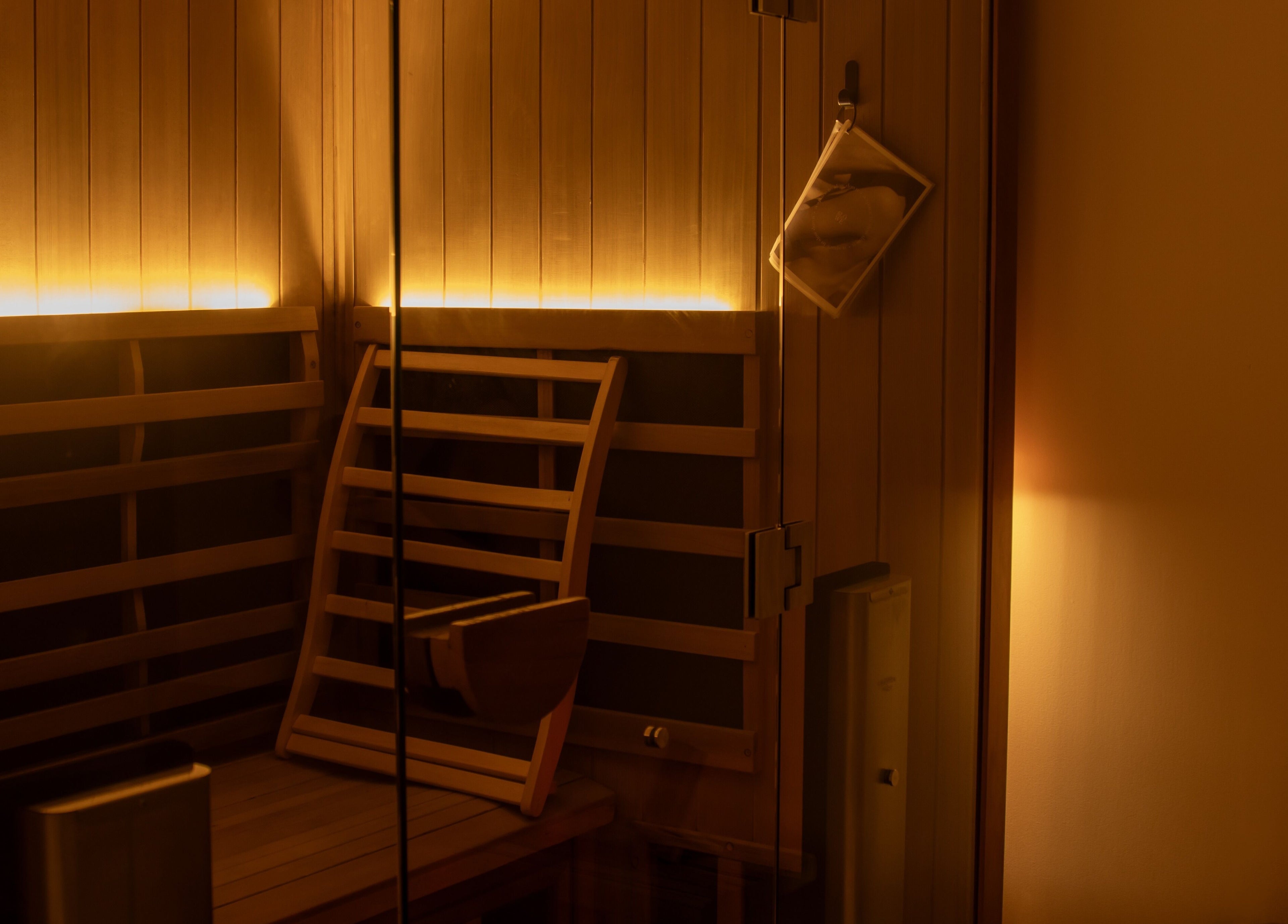 Cozy sauna room with warm lighting at Studio Sweat, Auckland, Auckland, NZ.