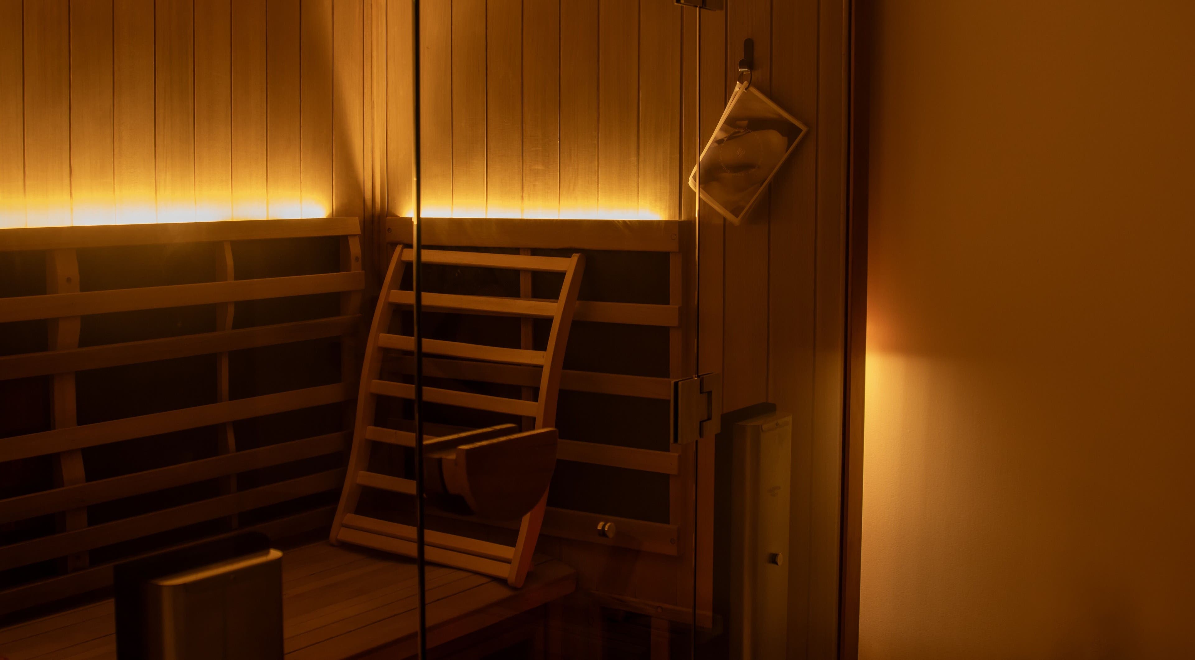 Cozy sauna room with warm lighting at Studio Sweat, Auckland, Auckland, NZ.