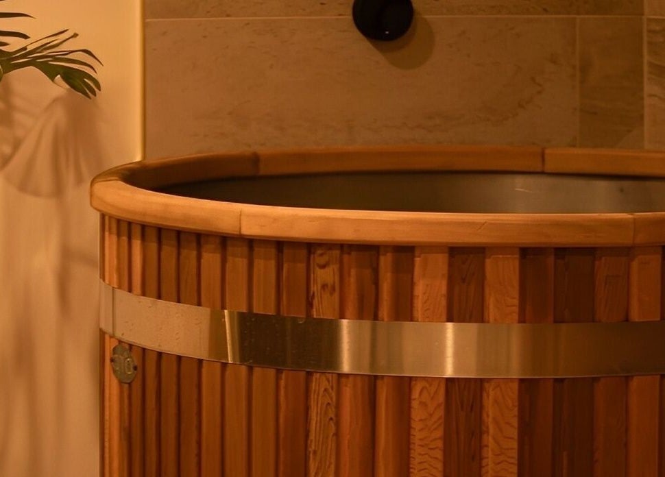 Wooden spa tub at Studio Sweat in Auckland, Auckland, NZ with plant nearby.
