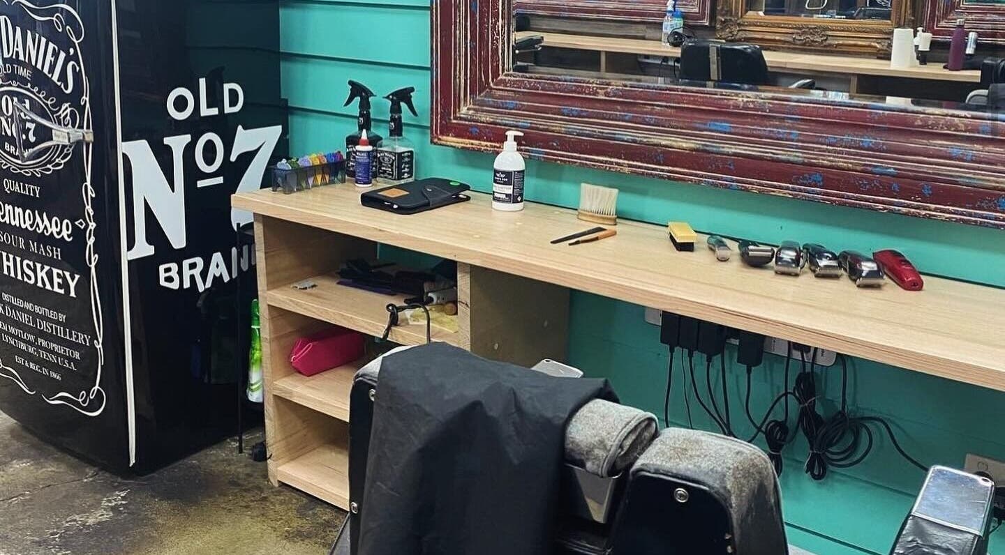The Alley Barber Frankston, VIC, AU: Vintage barber chair and grooming tools next to a classic mirror.