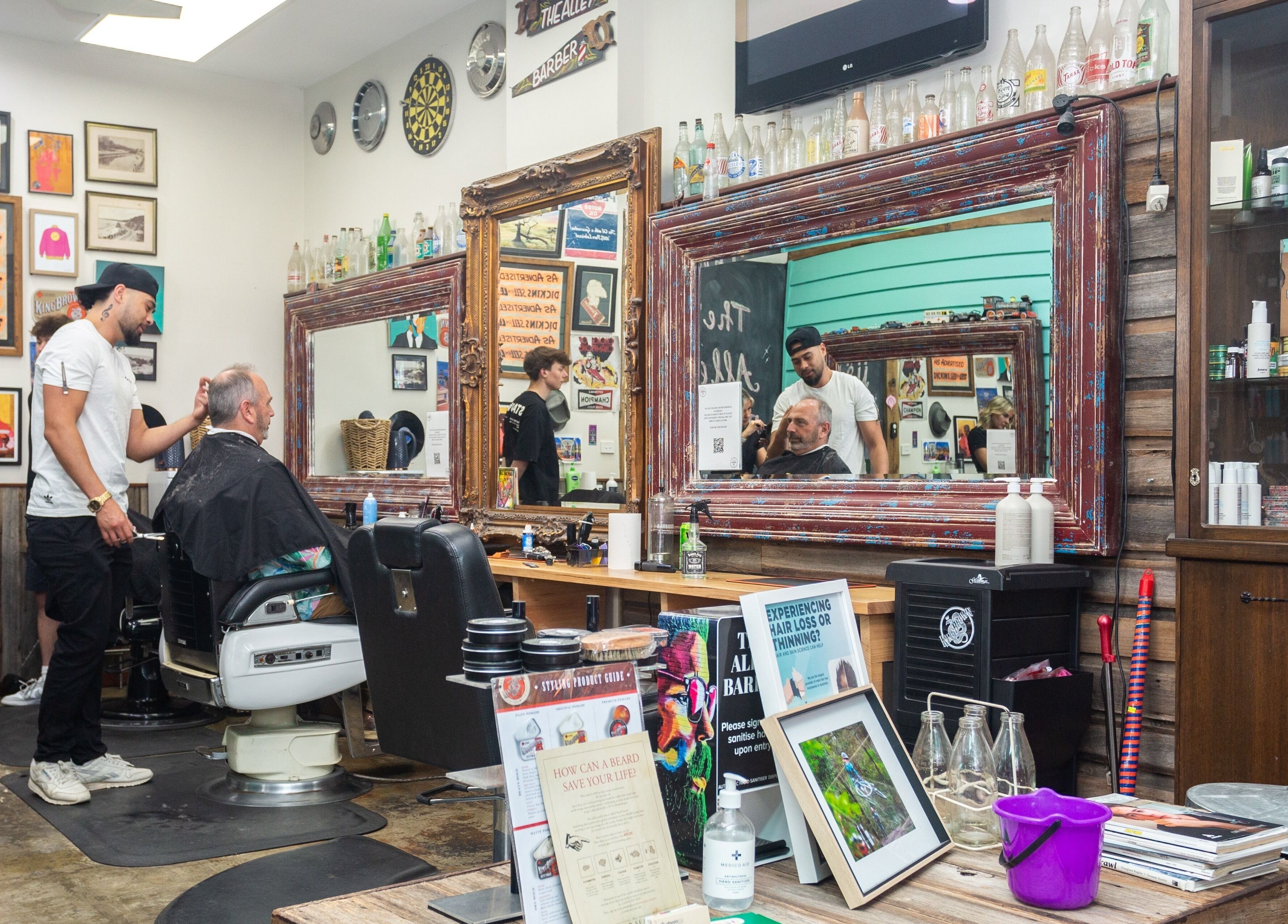 Stylish interior of The Alley Barber Frankston in Frankston, VIC, AU with patrons enjoying grooming services.
