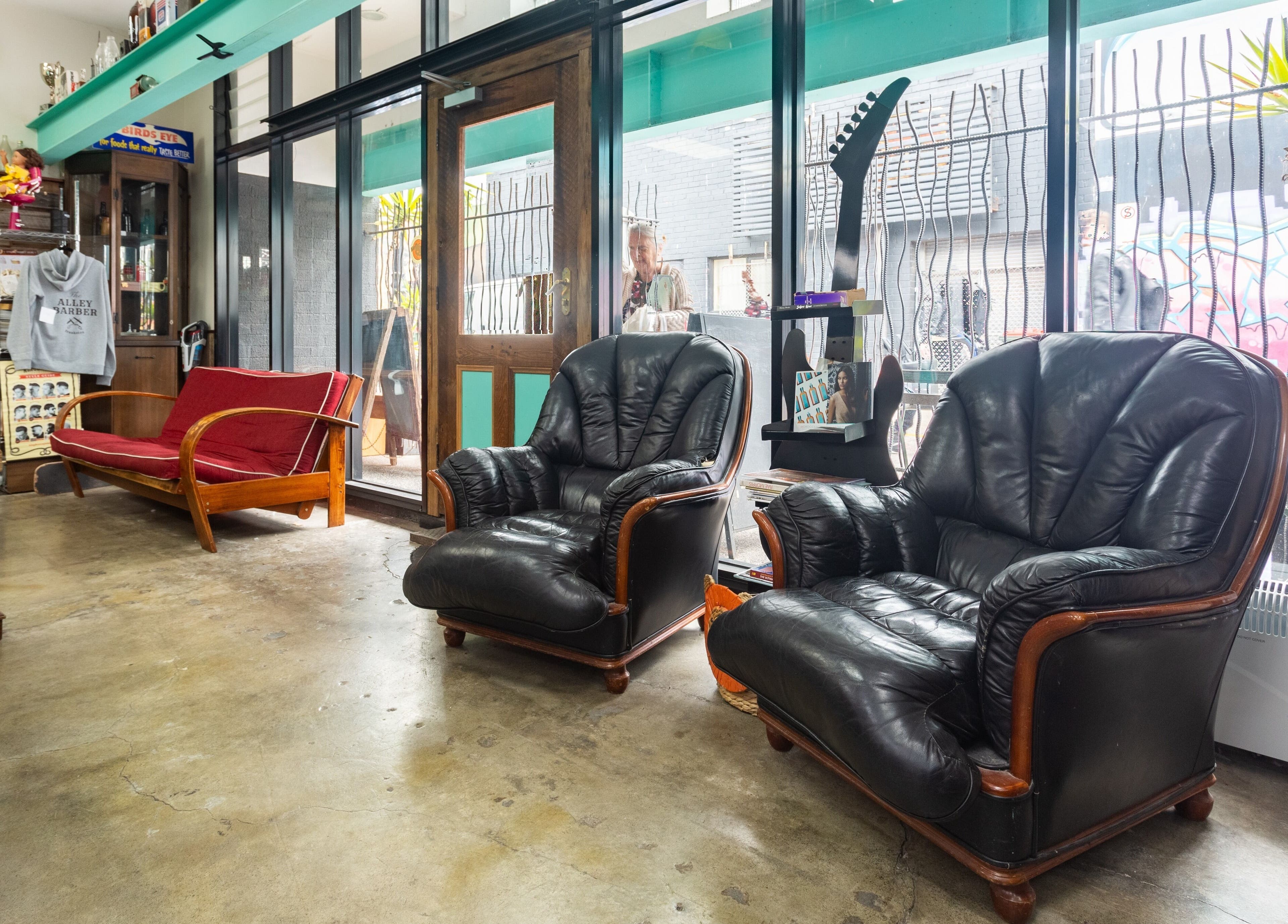 Lounge area with leather chairs at The Alley Barber Frankston, VIC, AU offering a cozy, stylish ambiance.