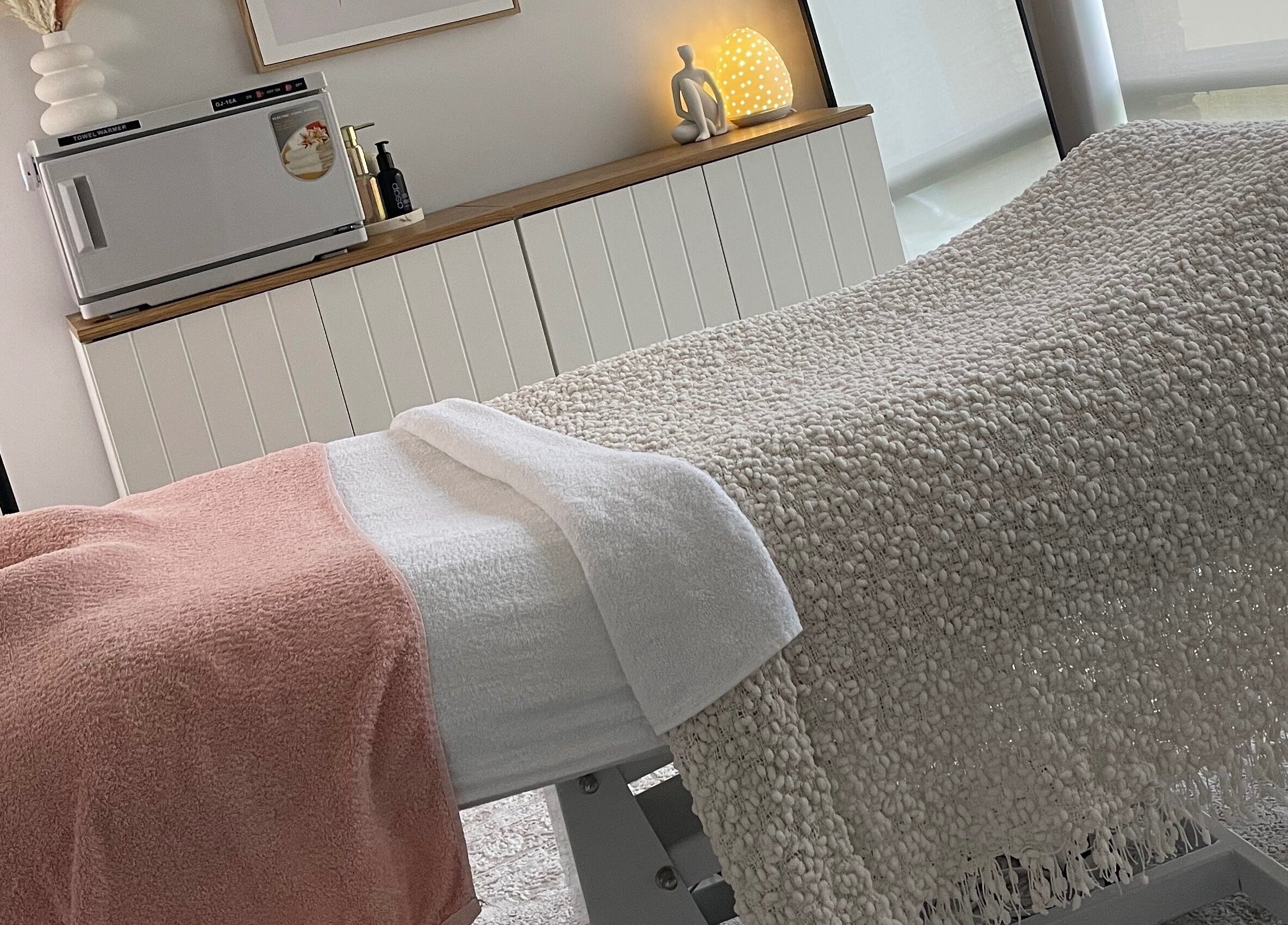 Relaxing spa room at Pure Bliss Skin Body And Beauty in Kinross, Western Australia, AU with cozy treatment bed.