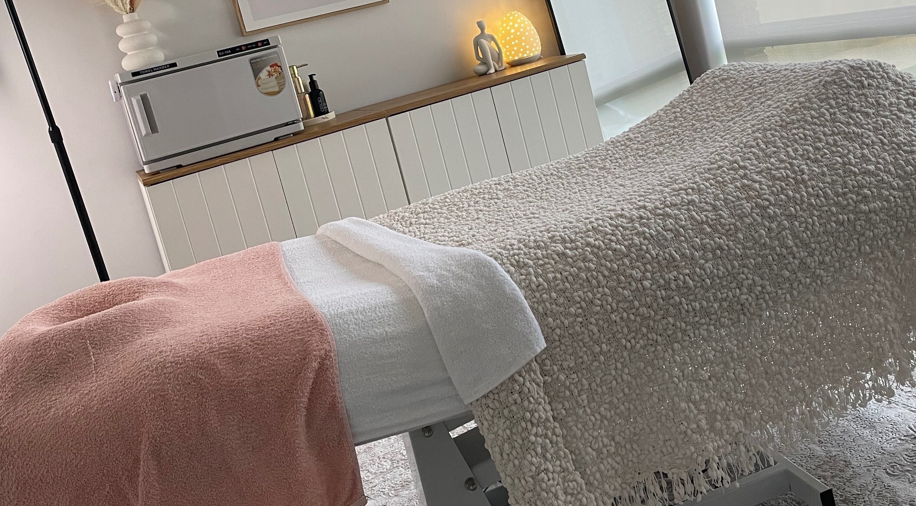 Relaxing spa room at Pure Bliss Skin Body And Beauty in Kinross, Western Australia, AU with cozy treatment bed.