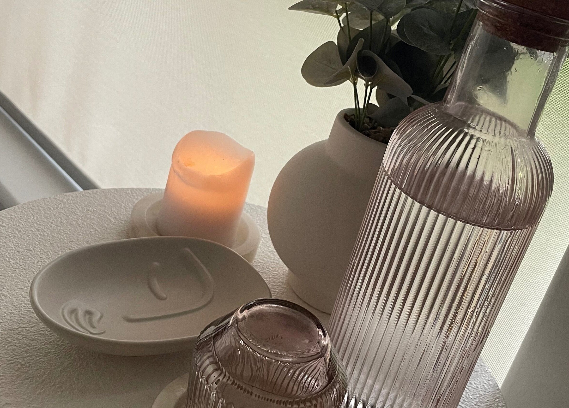Calming setup at Pure Bliss Skin Body And Beauty, Kinross, Western Australia, AU with candle and water decanter.