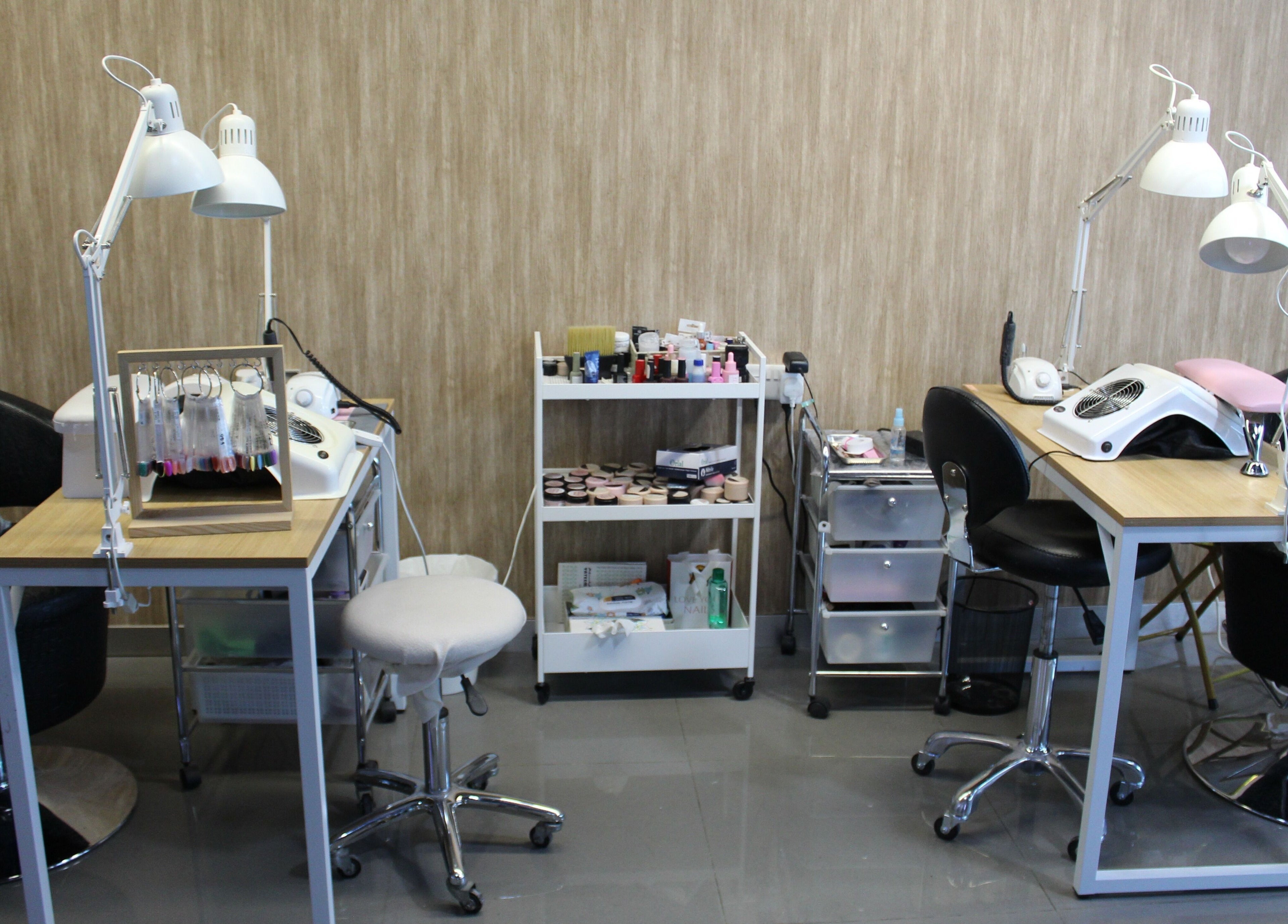Manicure stations at Bellissima Ladies Salon, Dubai, AE, featuring modern equipment and stylish seating.