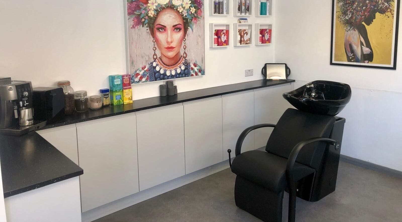 Elegant salon wash station at The Style Pod, Crawley, England, GB, highlighting modern decor and colorful art.