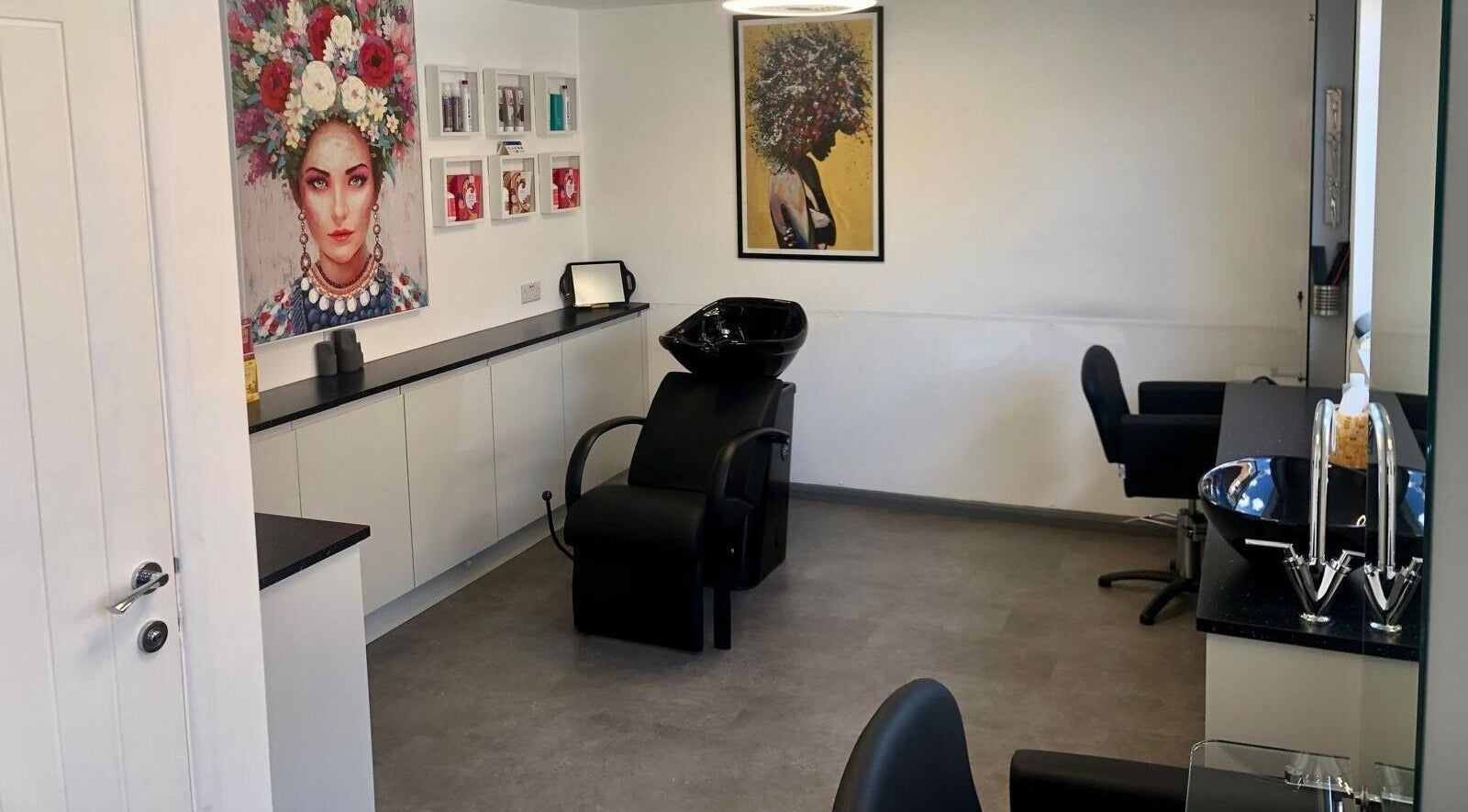 Modern hair salon interior at The Style Pod, Crawley, England, GB showcasing stylish decor and washbasin.
