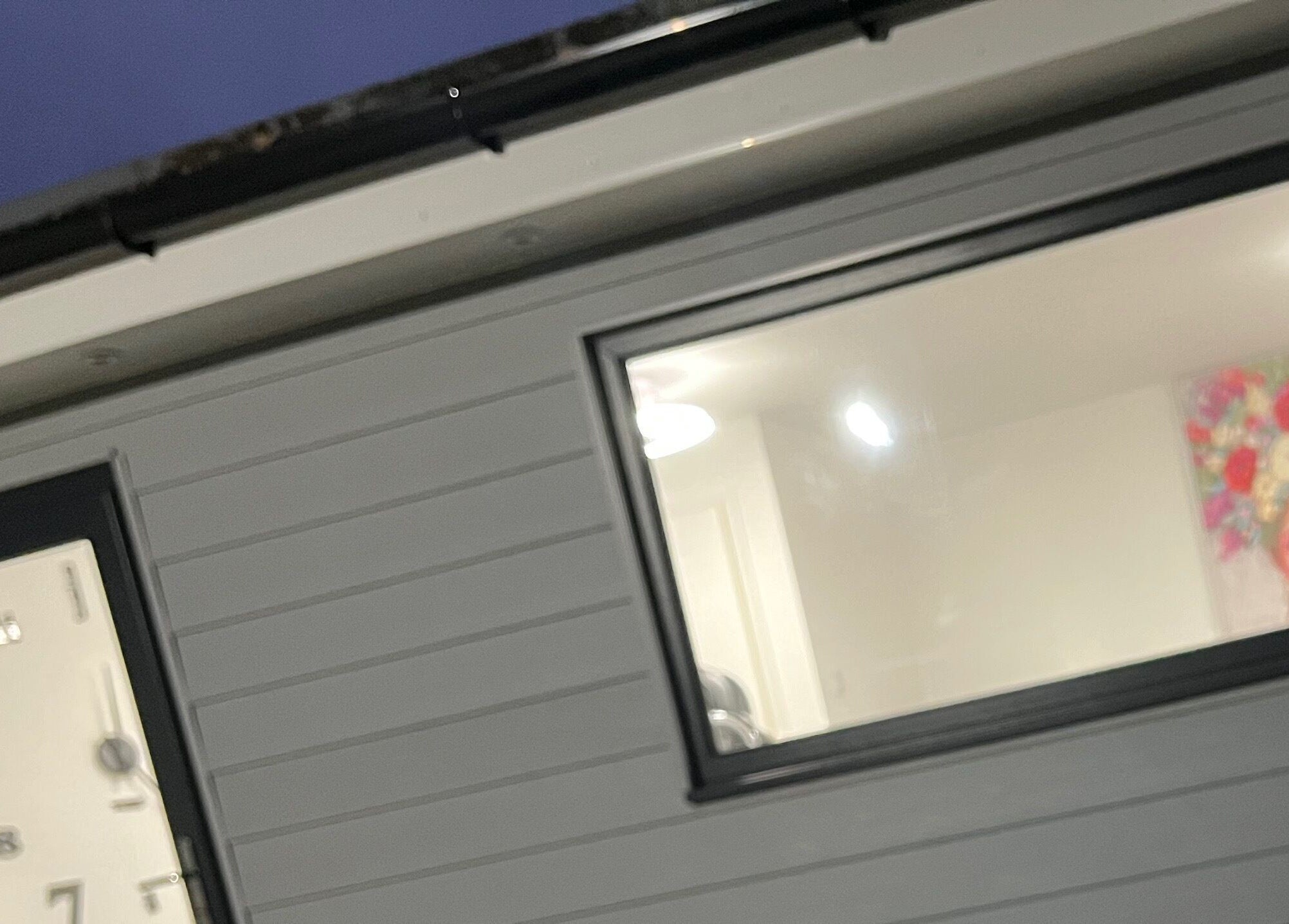 Exterior of The Style Pod in Crawley, England with artistic decor visible through the window.