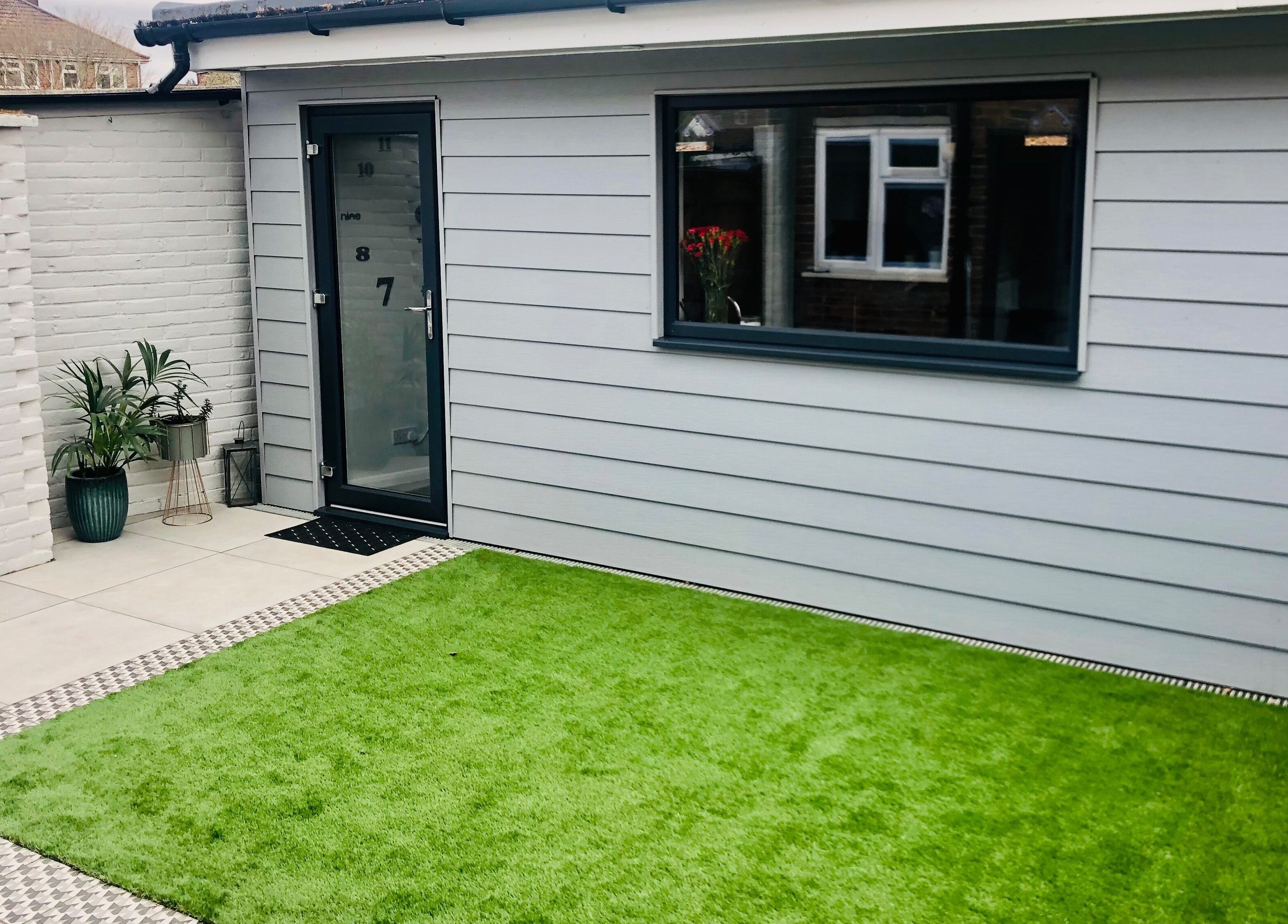 The Style Pod's sleek exterior in Crawley, England, GB featuring bright greenery and stylish decor.