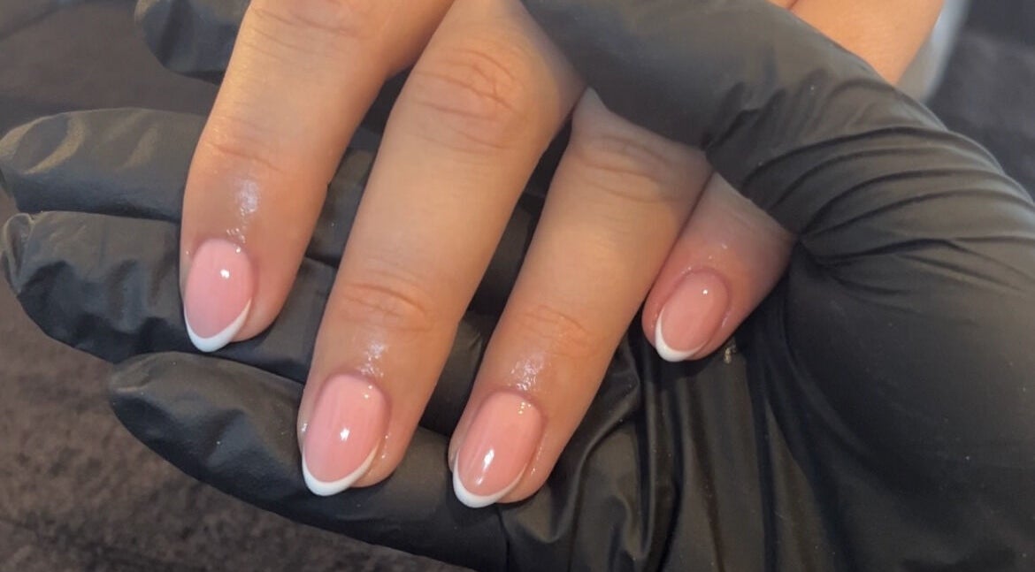 Glossy French manicure at TBM Studio in Bolton, England, GB showcasing skilled nail artistry.