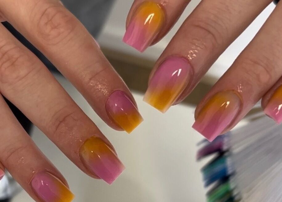 Colorful nail art at TBM Studio, Bolton, England, GB showcasing pink and orange gradient nails.