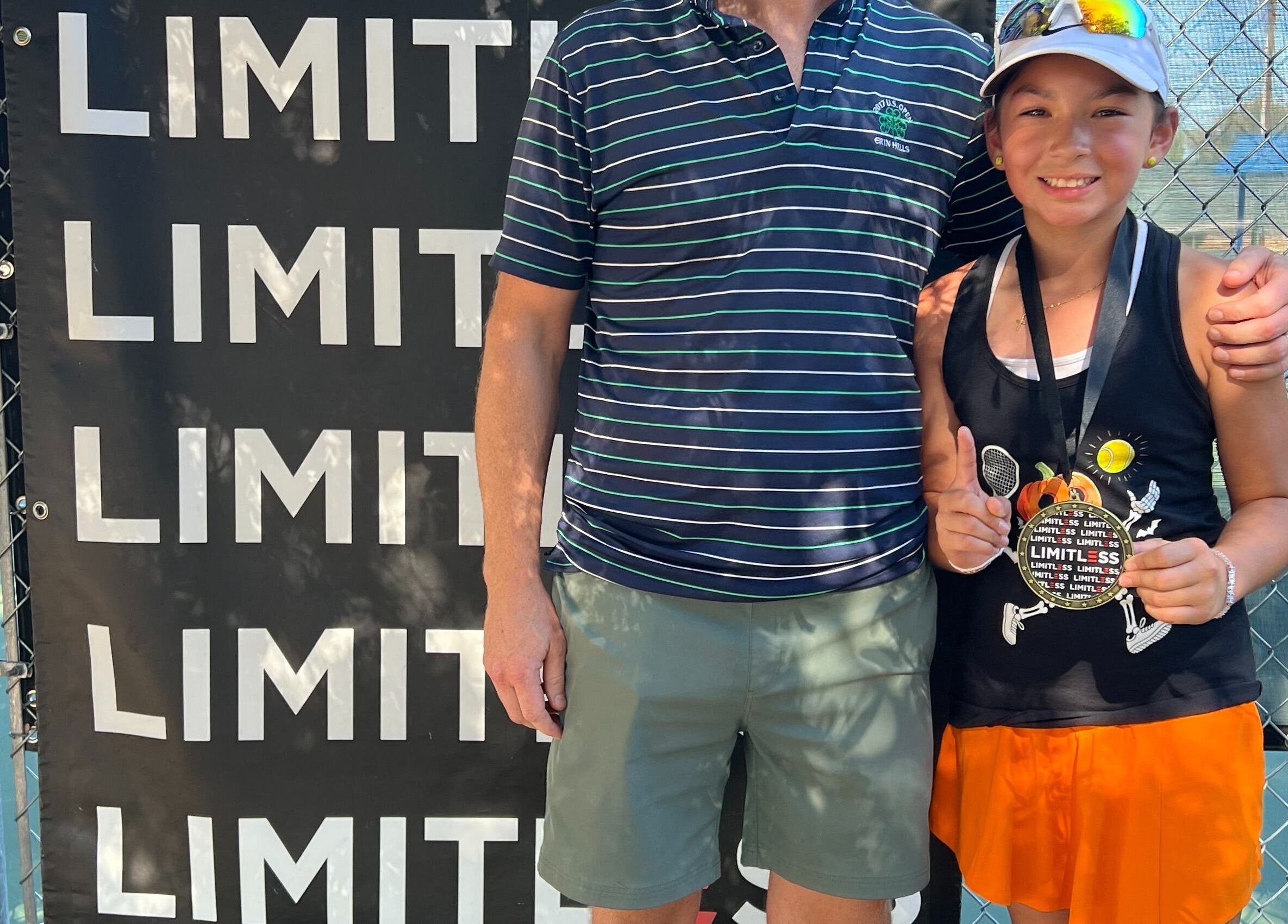 Young player with medal at Racket & Paddle Club, Gilbert, Arizona, US, showcasing victory and sportsmanship.