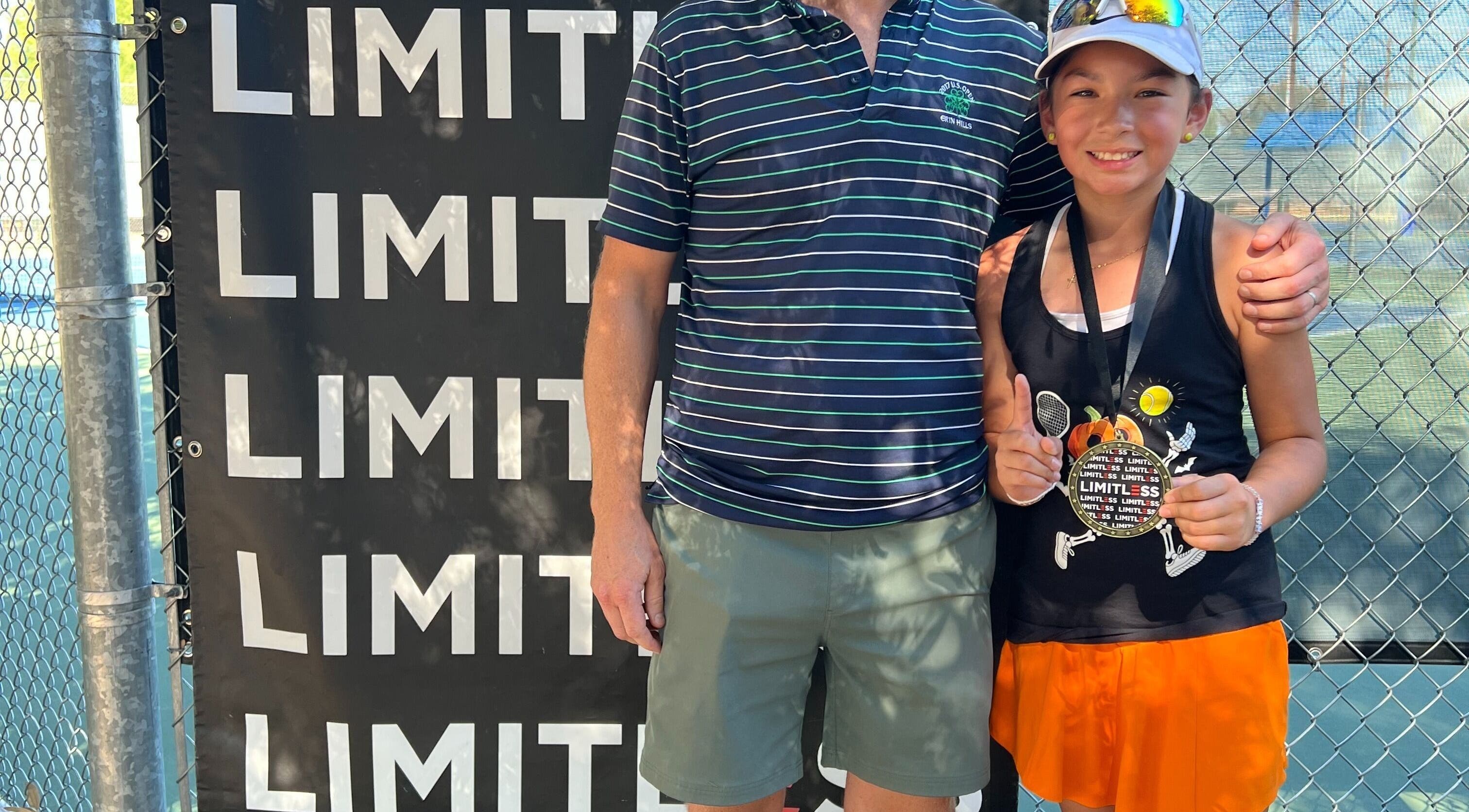 Young player with medal at Racket & Paddle Club, Gilbert, Arizona, US, showcasing victory and sportsmanship.