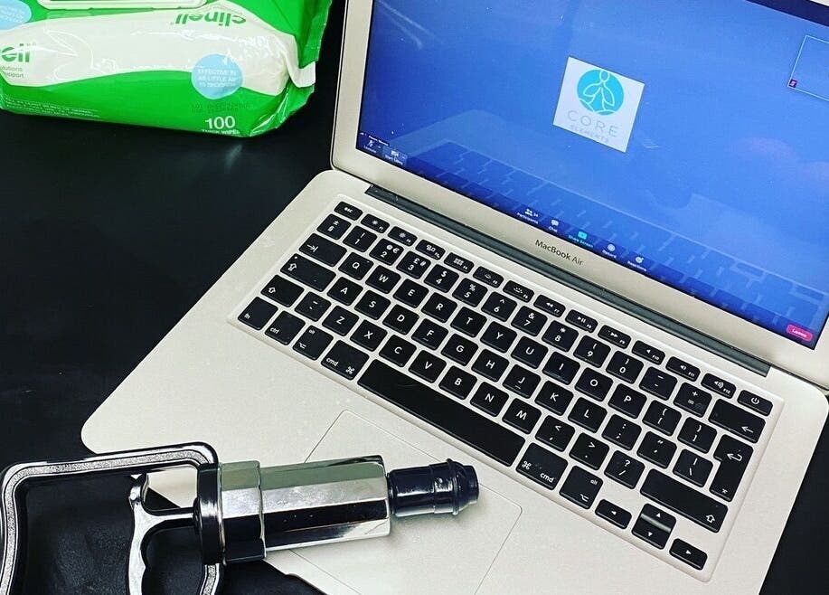 Sports Massage with E in Wellington, England, GB featuring a laptop and massage tool setup.