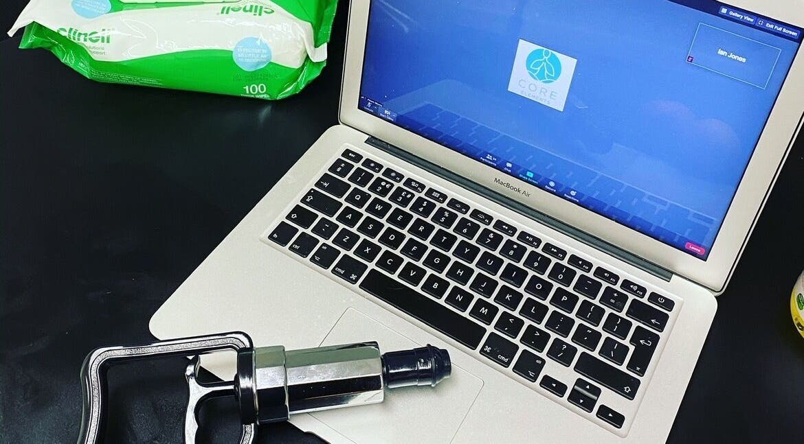 Sports Massage with E in Wellington, England, GB featuring a laptop and massage tool setup.