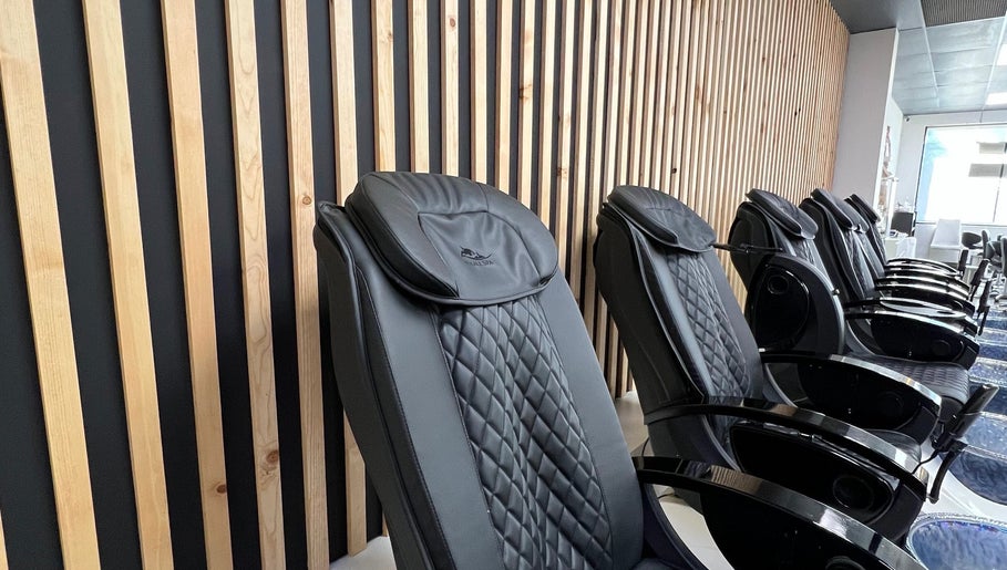 Sleek massage chairs at Gloss Spa, Lenexa, Kansas, US, offering ultimate relaxation in a modern setting.