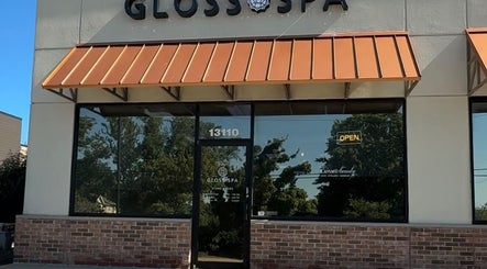Entrance of Gloss Spa in Lenexa, Kansas, US featuring a modern facade with large glass windows.