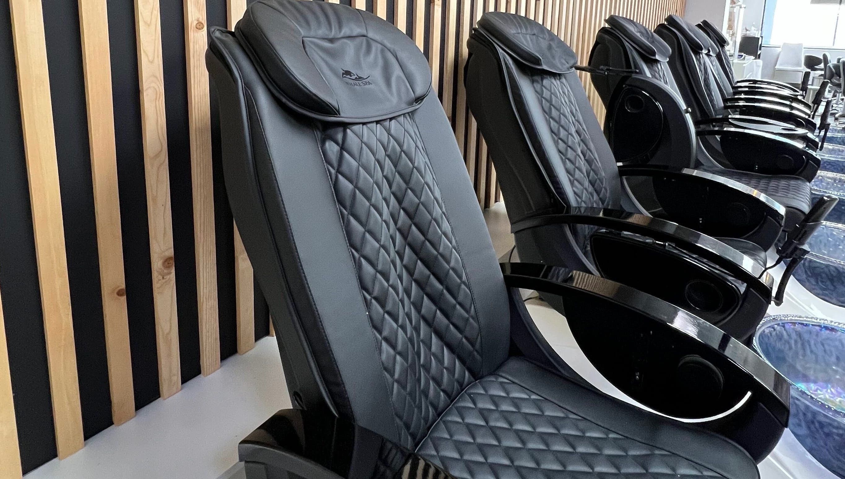 Elegant black massage chairs at Gloss Spa, Lenexa, Kansas, US offer ultimate relaxation.