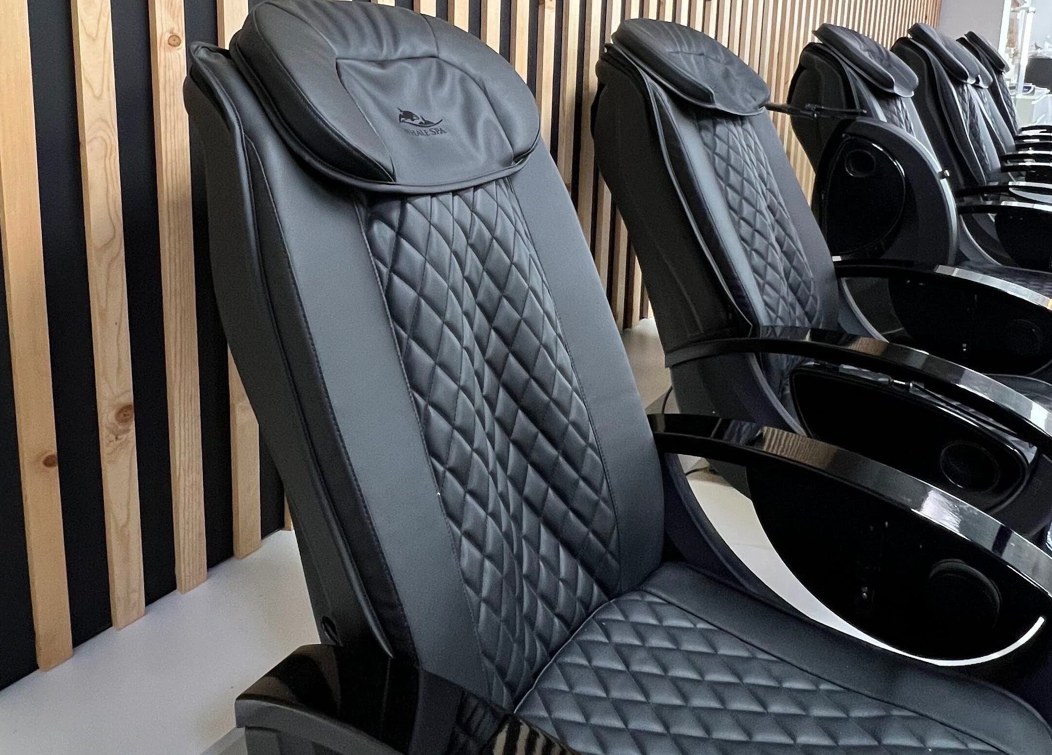 Elegant black massage chairs at Gloss Spa, Lenexa, Kansas, US offer ultimate relaxation.