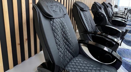 Elegant black massage chairs at Gloss Spa, Lenexa, Kansas, US offer ultimate relaxation.