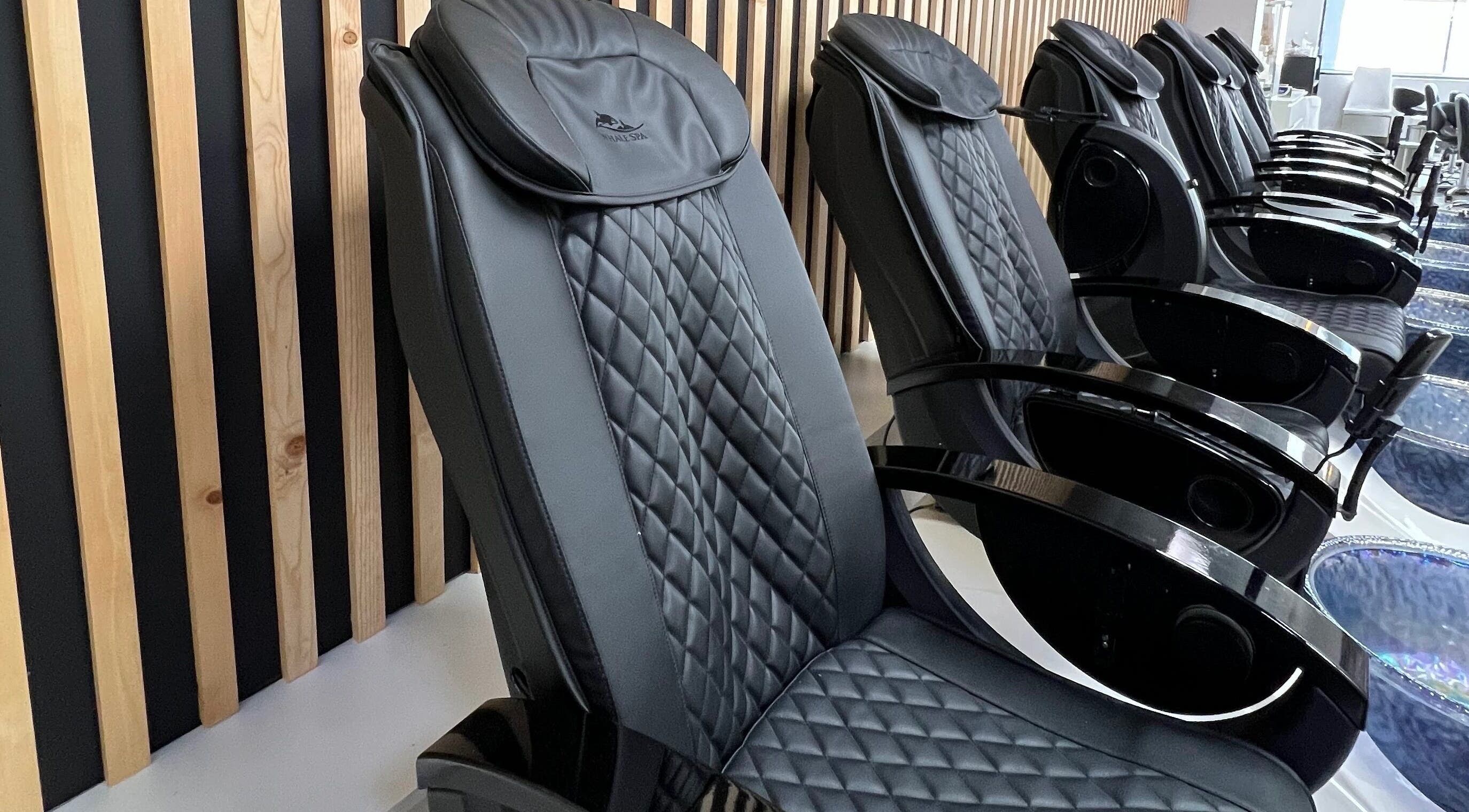 Elegant black massage chairs at Gloss Spa, Lenexa, Kansas, US offer ultimate relaxation.