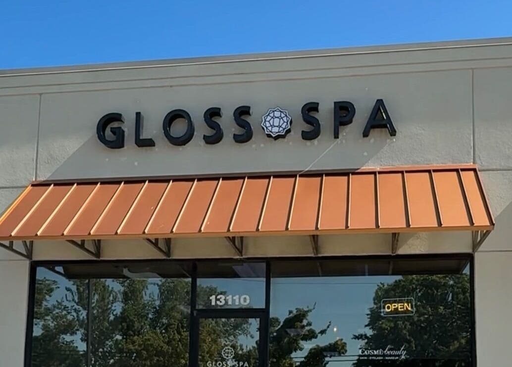 Front entrance of Gloss Spa in Lenexa, Kansas, US with modern signage and awning.
