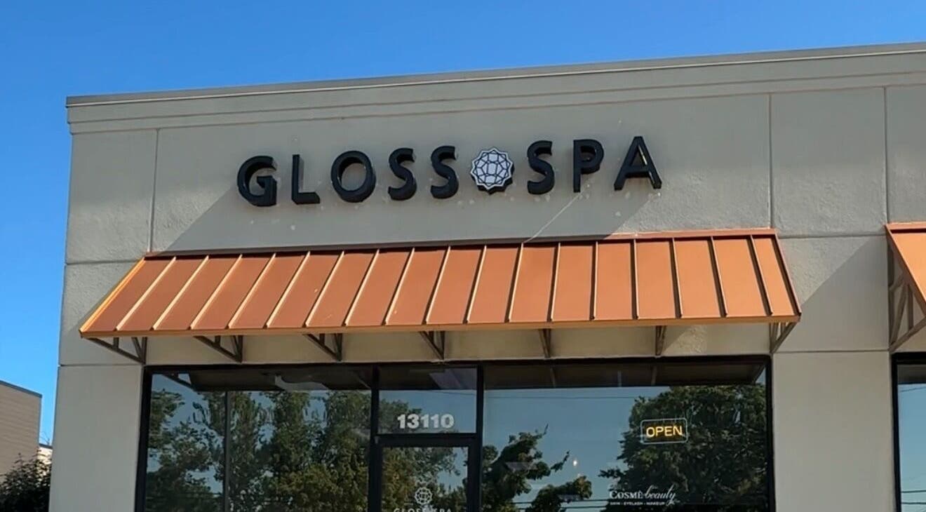 Front entrance of Gloss Spa in Lenexa, Kansas, US with modern signage and awning.