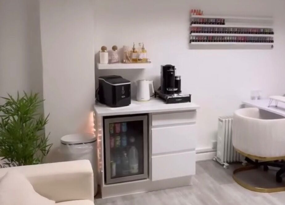 Chic salon interior at Dose of Beauty, Westcliff-On-Sea, GB, featuring a nail polish display and seating area.