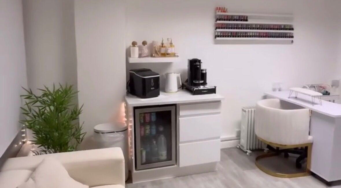 Chic salon interior at Dose of Beauty, Westcliff-On-Sea, GB, featuring a nail polish display and seating area.