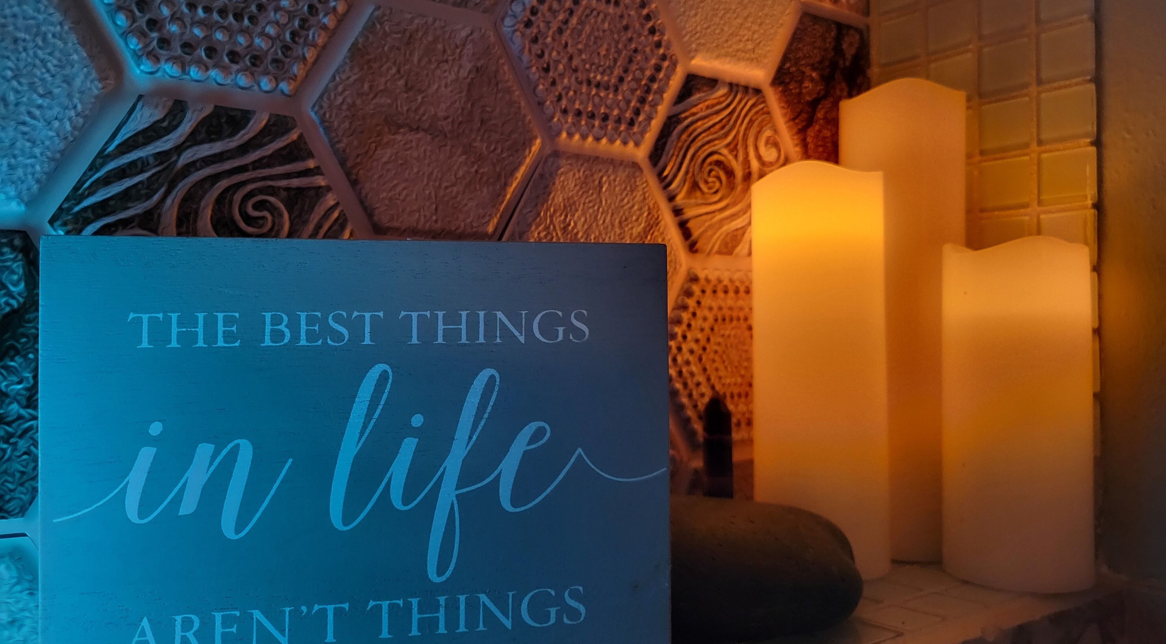 Candles and motivational sign at The Compass Spa Therapy & Wellbeing in Tampa, Florida, US radiate serenity.