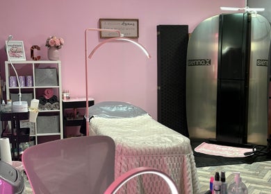 Inside Clarissa's Beauty Boutique in March, England. Modern treatment room with pink decor and cozy ambiance.