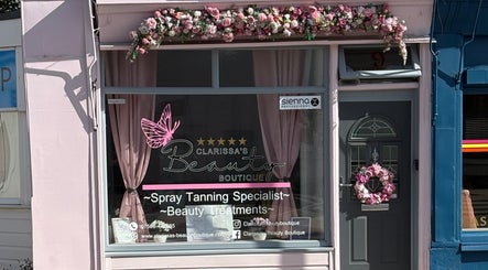 Exterior of Clarissa's Beauty Boutique in March, England, GB adorned with floral decorations.