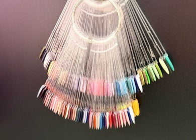 Colorful nail polish samples at Clarissa's Beauty Boutique, March, England, GB, showcasing vibrant options.