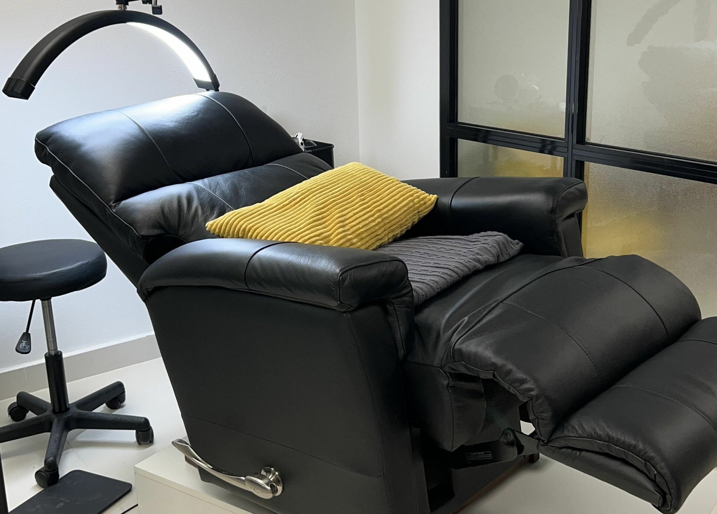 Comfortable recliner and stool at Get Lashed Beauty Lounge, Abu Dhabi, Abu Dhabi, AE for a relaxing experience.