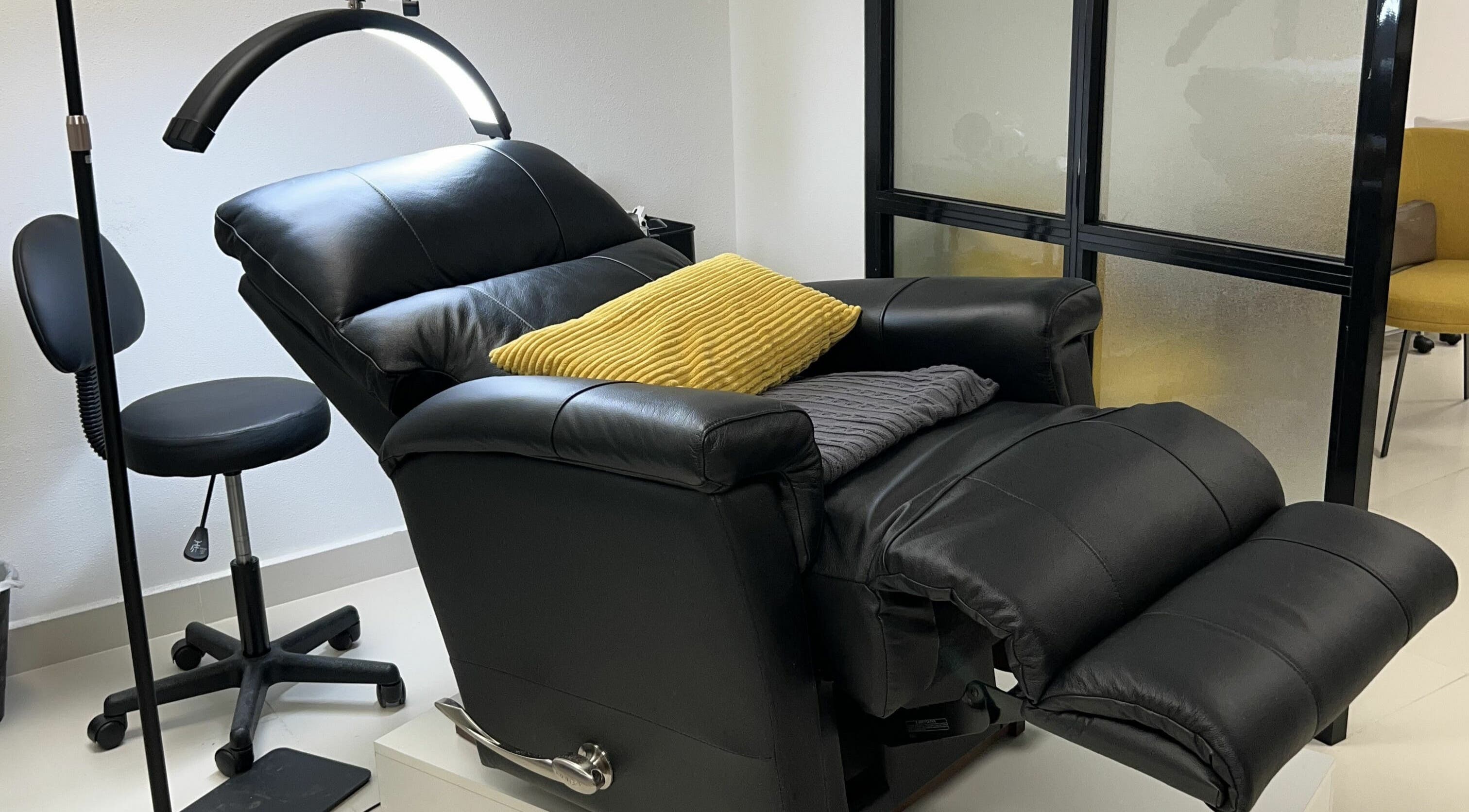 Comfortable recliner and stool at Get Lashed Beauty Lounge, Abu Dhabi, Abu Dhabi, AE for a relaxing experience.