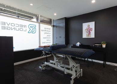Massage room at My Recovery Lounge, Port Melbourne Beach, Victoria, AU with treatment table and modern decor.