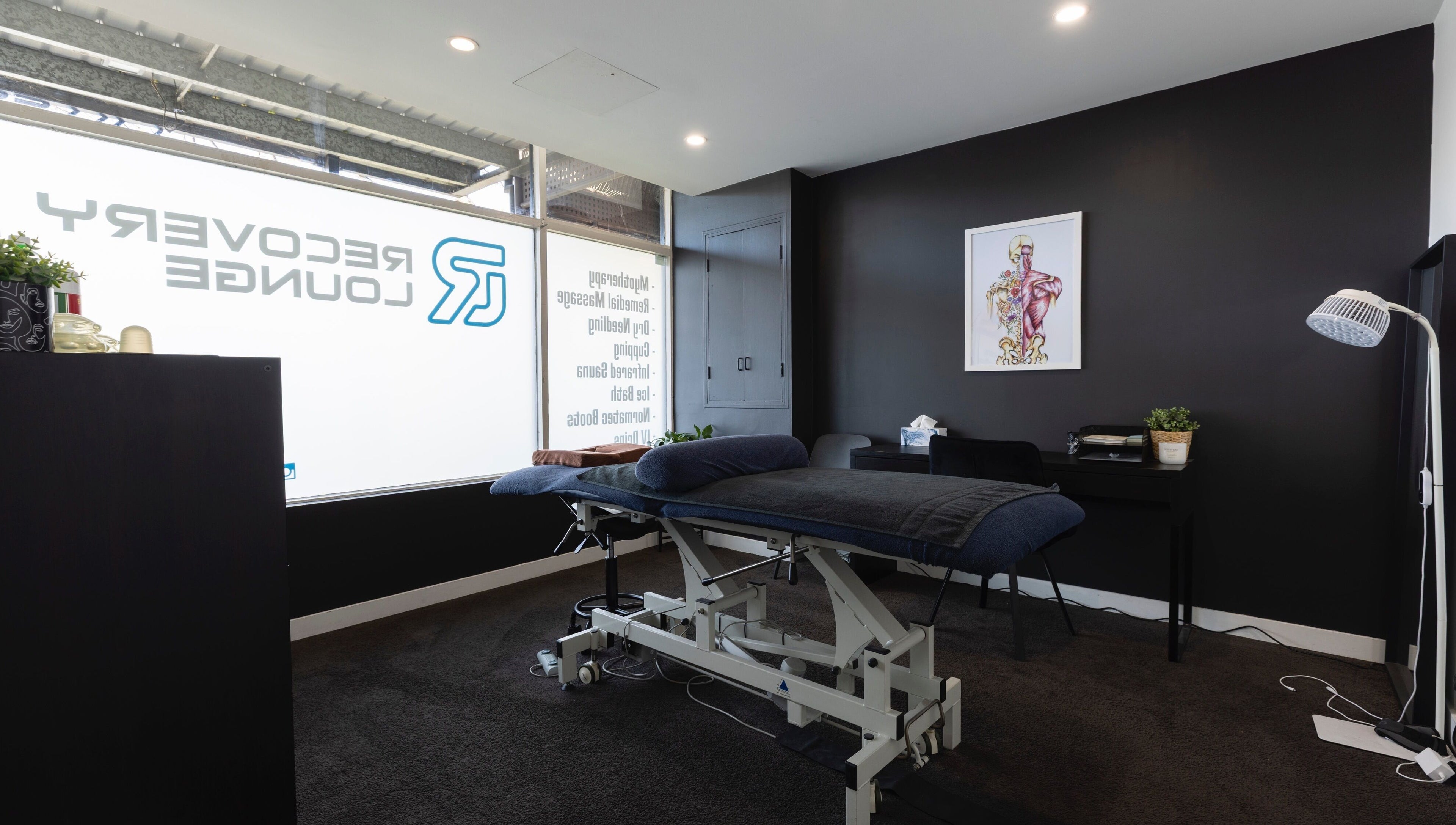 Relaxing treatment room at My Recovery Lounge, Port Melbourne Beach, Victoria, AU with massage bed and decor.