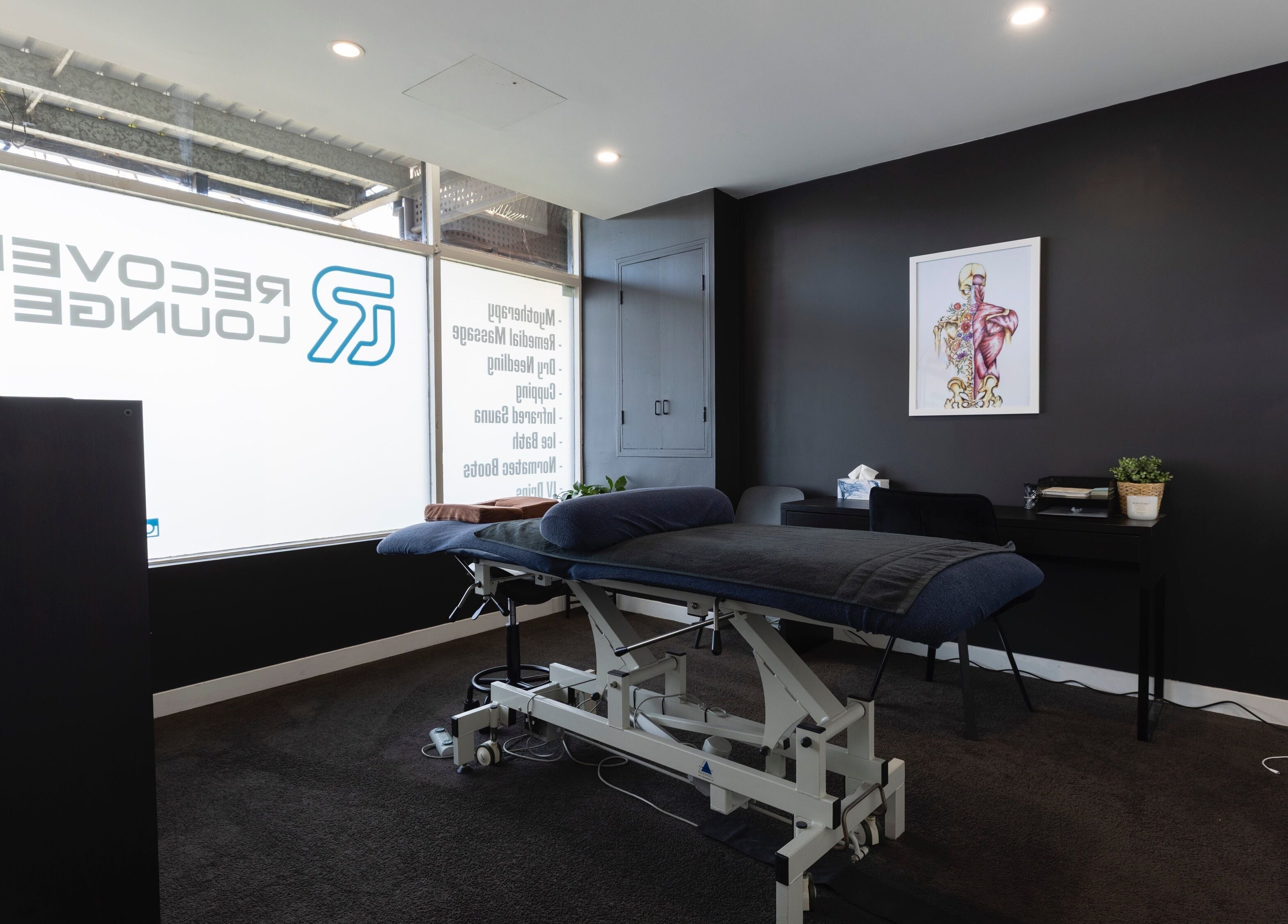 Relaxing treatment room at My Recovery Lounge, Port Melbourne Beach, Victoria, AU with massage bed and decor.