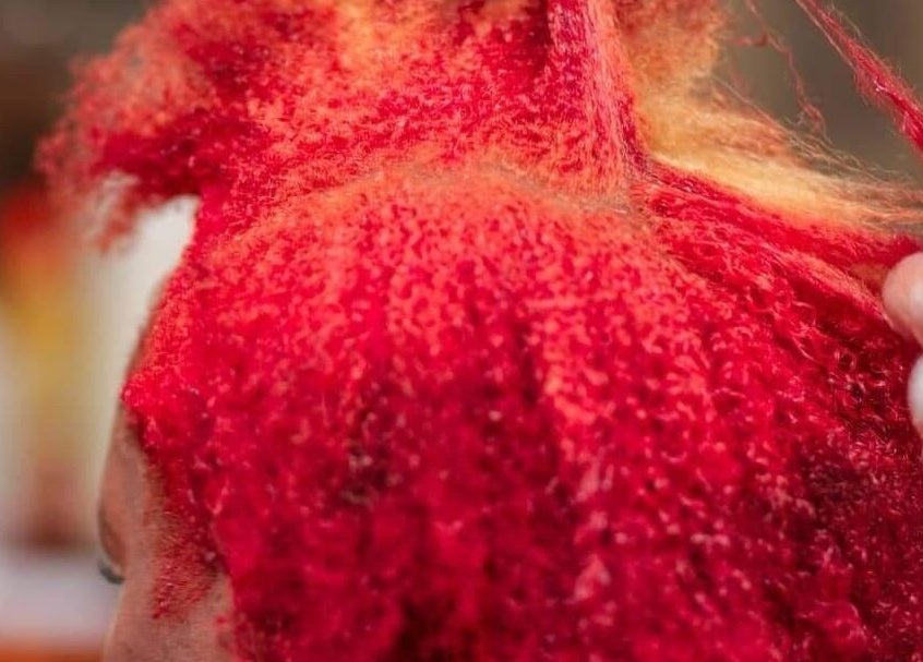 Hair coloring in progress at Georgekutz Hair Studio, Seeb, Muscat Governorate, OM. Vibrant red shades being applied.