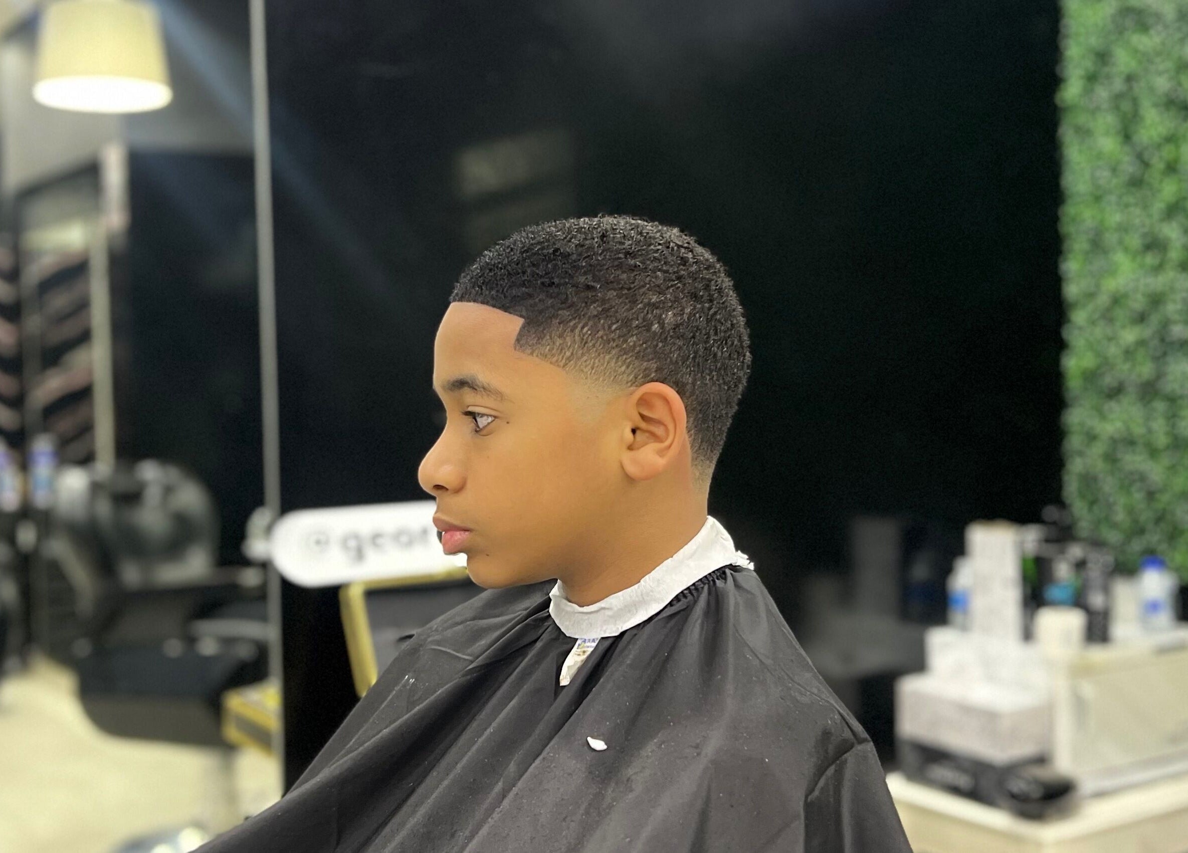 Stylish haircut at Georgekutz Hair Studio, Seeb, Muscat Governorate, OM, featuring a clean fade.