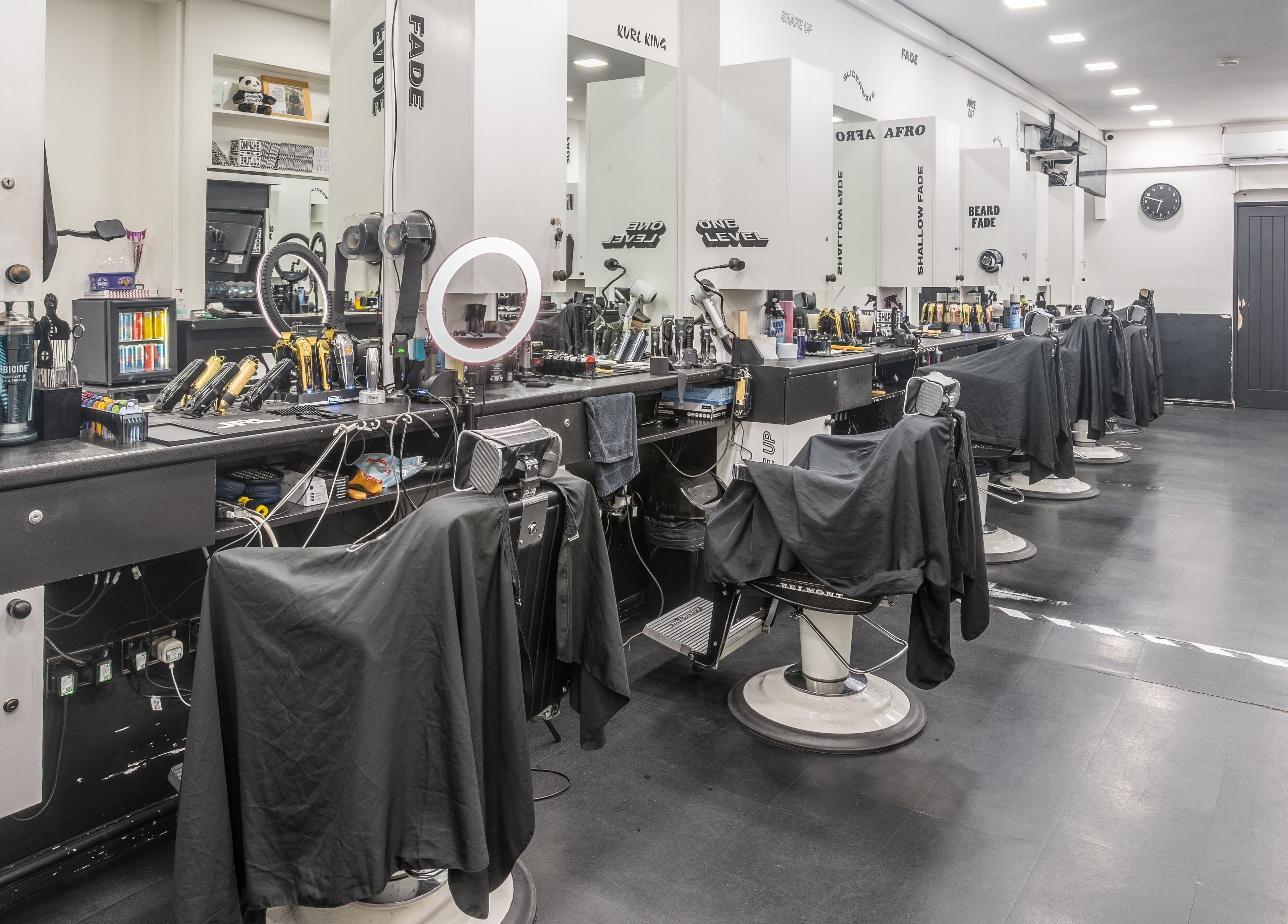 Contemporary barber chairs at SliderCuts, London, England, GB, showcasing sleek salon interior.