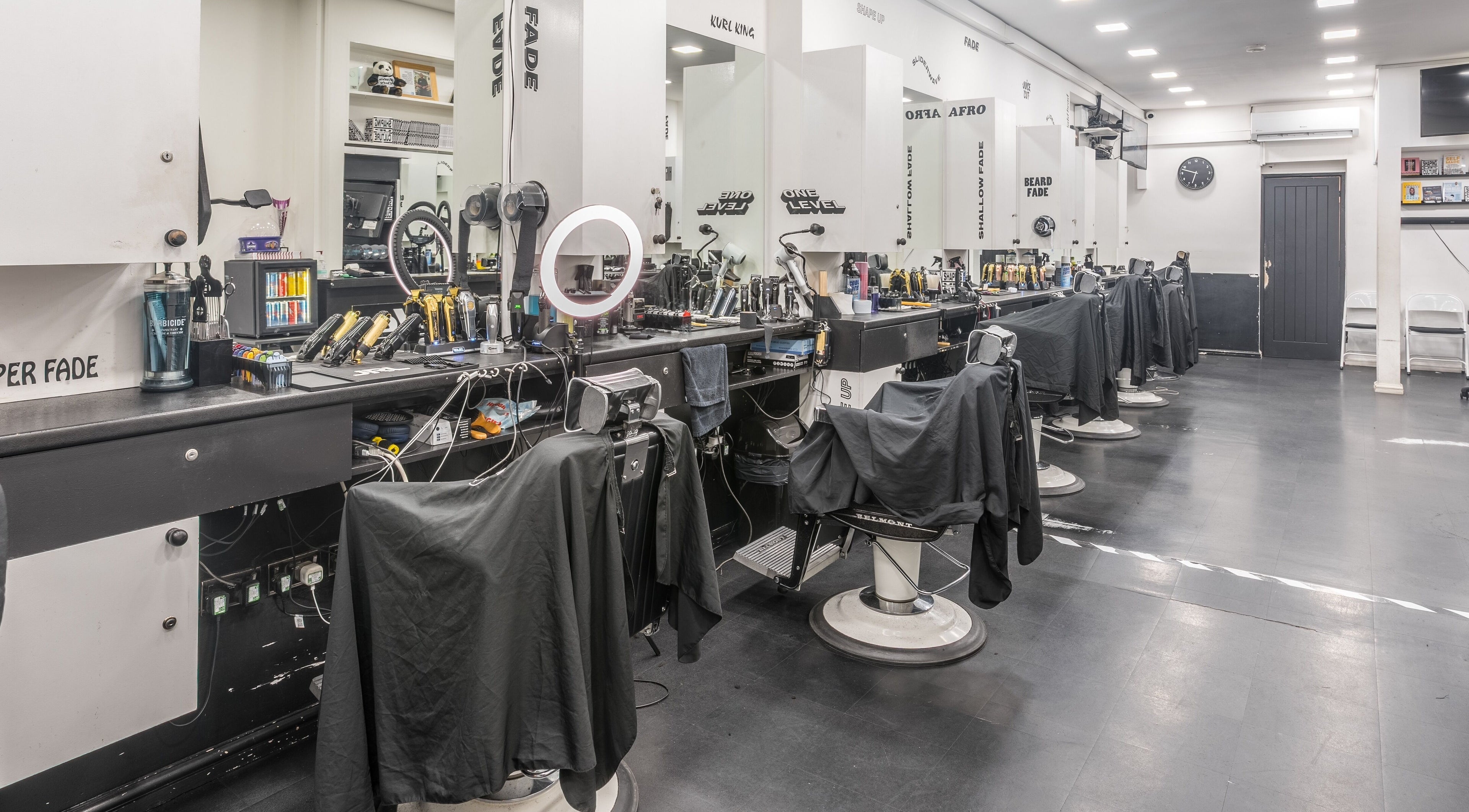 Contemporary barber chairs at SliderCuts, London, England, GB, showcasing sleek salon interior.